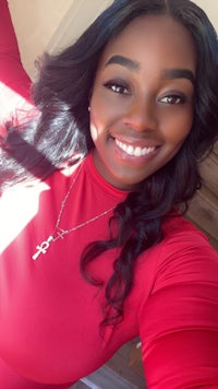 a young black woman in a red dress posing for a photo